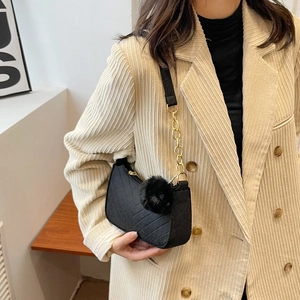Black quilted crossbody bag with stylish fur pompom and golden chain strap for women