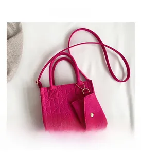 Detail view of pink felt tote bag with embossed floral texture and matching coin purse