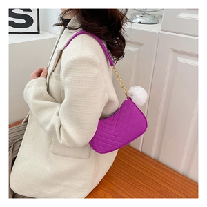 Chic purple quilted shoulder bag with gold chain strap and plush white charm detail