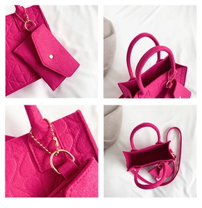 Detail view of pink felt handbag set with embossed pattern and gold chain link accessories
