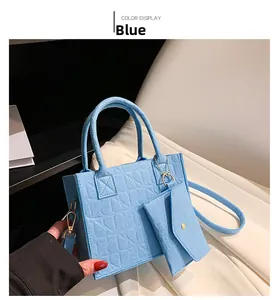Blue felt tote bag detail with geometric texture, matching mini pouch and gold hardware