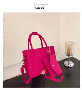 Detail view of rose red felt handbag set with embossed texture and gold chain strap