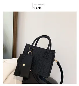 Detail of black felt crossbody bag with embossed patterns and matching coin purse pouch