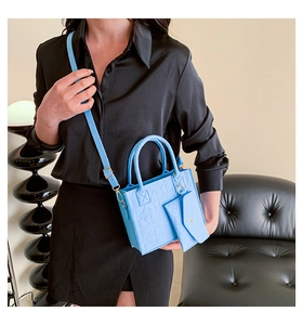 Sky blue textured leather tote bag set shown with detachable shoulder strap and pouch