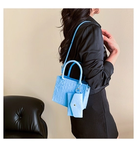 Sky blue felt tote bag with geometric texture and small purse shown on a model