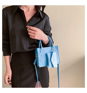 Detail of light blue felt tote bag set with heart texture and adjustable strap