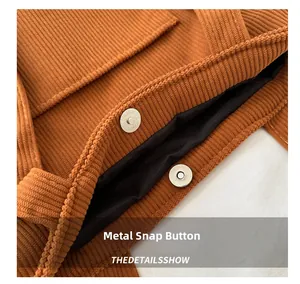 Detailed view of brown corduroy tote bag showing the magnetic snap closure mechanism