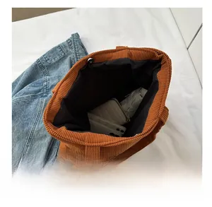 Interior view showing the large capacity and magnetic buckle of the corduroy tote bag