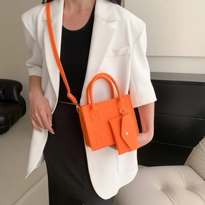Bright orange felt tote bag set with embossed texture and adjustable shoulder strap