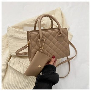 Close-up of taupe quilted crossbody bag with golden hardware and matching coin purse