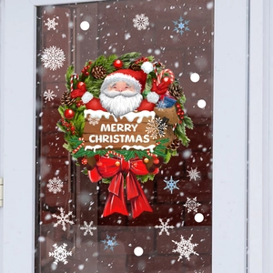 Detail of Santa Claus wreath window sticker with snowflakes on glass pane