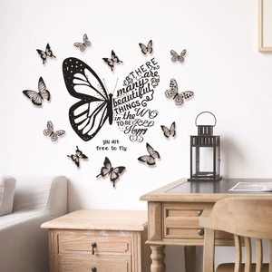 Detail of black 3D butterfly wall stickers with inspirational quotes on a white wall
