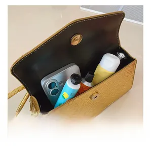 Detailed interior view of the square handbag showing space for phone and cosmetics