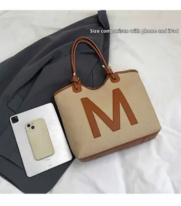 Detailed comparison of the woven tote bag size shown next to an iPad and a smartphone