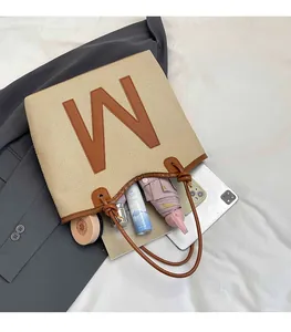 Top view of beige woven tote bag interior showing spacious capacity for tablets and daily items