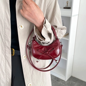 Burgundy bow-knot hobo bag with glossy finish and silver sphere charm detail
