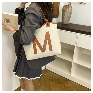 Canvas tote bag with large M letter showing spacious interior for daily commute