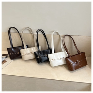 Detail view of stylish tote bags in five colors with polished leather and metal buckles