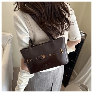 Vue détaillée du sac bandoulière en cuir vintage avec boucle dorée et texte embossé