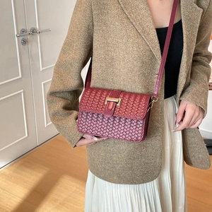 Woven leather crossbody bag in burgundy with gold buckle hardware for daily use