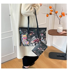 Detail view of the black graffiti tote bag set with a matching small zipper pouch