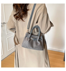 Dark grey bucket bag crossbody on trench coat showing daily style and product size
