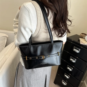 Minimalist black matte leather tote bag with metal buckle strap for daily commuting