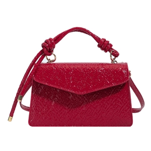 Red pebbled leather crossbody bag for women with knotted handle and gold hardware