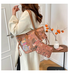 Detail of a brown graffiti crossbody bag with bear prints and a matching small zipper pouch