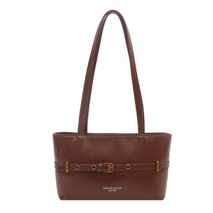 Dark brown retro leather shoulder bag with decorative strap and gold buckle on white background