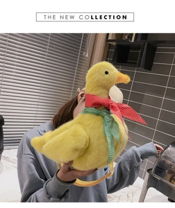 Detailed close-up of cute yellow plush duck crossbody bag with colorful neck scarves