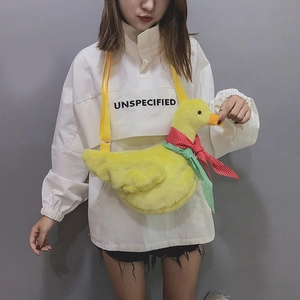 Cute yellow plush duck crossbody bag with polka dot scarf shown on a model