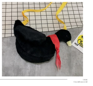 Detail of cute black plush goose bag featuring a polka dot scarf and yellow shoulder strap