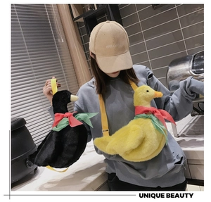 Cute duck plush shoulder bag with colorful bow details worn by a model in daily life