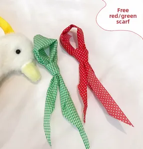 Detail view of red polka dot and green checkered plush scarves for duck bags