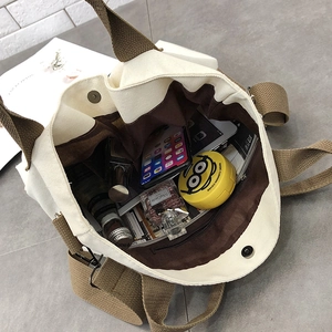Interior view showing large capacity and multiple pockets of the canvas tote bag