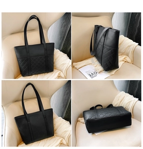 Detail view of black quilted faux leather tote bag with large capacity and double straps