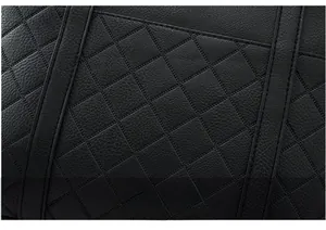 Detail shot of black leather tote bag with classic diamond quilted stitching pattern