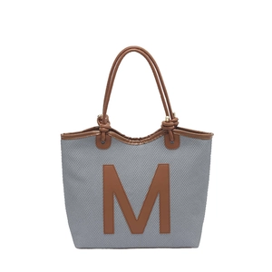 Retro grey woven tote bag with brown leather trim and large letter M decoration