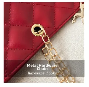 Detail of red quilted leather bag featuring gold chain and golden deer charm accessory