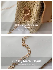 Detail of detachable golden metal chain strap on a straw woven crossbody bag