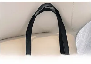 Detail of black tote bag with dual handles featuring high-quality lychee grain leather