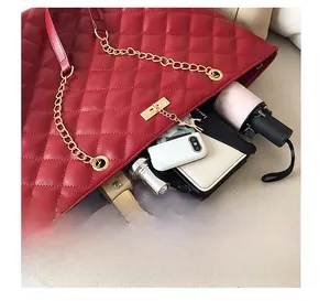 Interior view of the red quilted tote bag showing large capacity for tablet and items