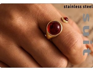 Close-up of gold-plated stainless steel open ring with two red garnet stones on finger