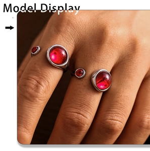 Macro shot of silver adjustable rings with red garnet-style gemstones on model hand
