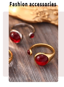 Detail of garnet open ring with polished red stone and vintage gold metal finish