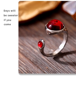 Detailed macro view of adjustable silver ring with two radiant red garnet stones