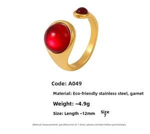 Detailed close-up of adjustable stainless steel ring with two red garnet cabochons