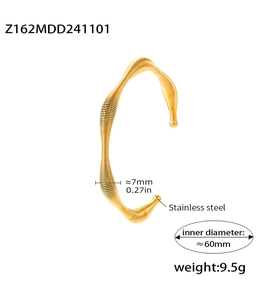 Detail view of gold spiral textured stainless steel bangle with dimensions and weight specs