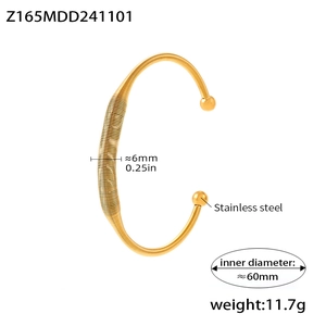Detail view of irregular gold spring coil bracelet with dimensions and weight specs